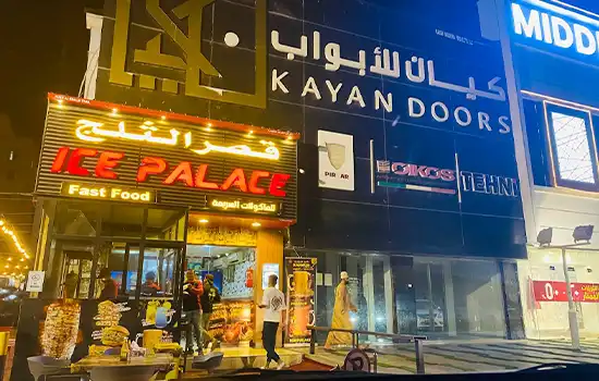 An image of a fast food shop in Oman featuring shawarma for sale