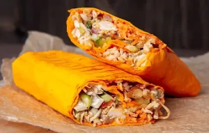 Image of two delicious shawarma pieces wrapped in brown paper.